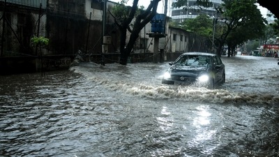 Vehicles wade through the waterlogged road following heavy rainfall in Hyderabad on Monday.&nbsp; (ANI)