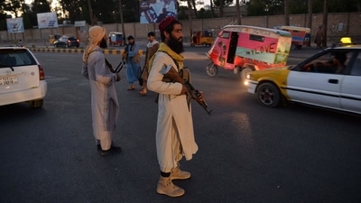 Taliban fighters stand guard along a road in Herat. (AFP File Photo)