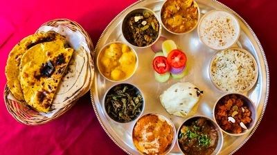 Rajasthani Thali: You need to try the traditional Rajasthani Thali whenever you are in Rajasthan next. It comprises authentic Rajasthani dishes like Dal Bati Churma, Kachori, Gatta Saag, Wadi, Ker Sangri, Ghevar and many more. (Unsplash) Rajasthani Thali: You need to try the traditional Rajasthani Thali whenever you are in Rajasthan next. It comprises authentic Rajasthani dishes like Dal Bati Churma, Kachori, Gatta Saag, Wadi, Ker Sangri, Ghevar and many more. (Unsplash)