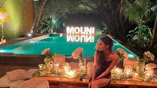 Mouni Roy happily posed in front of an aesthetic background that also featured a pool.(Instagram/@imouniroy)