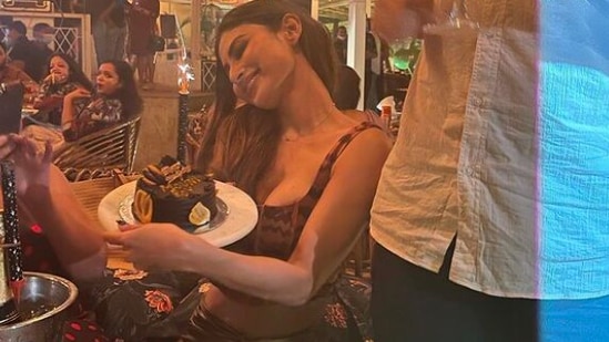 Mouni Roy is like a kid in a candy store as she holds on to her birthday cake tight.(Instagram/@imouniroy)