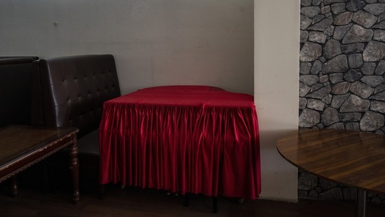 A grand piano is covered in a red cloth inside a hookah bar in Kabul, on September 21. In the family home of another ustad in Kharabat, everyone’s bags are packed, ready to leave when they can. In one room, a group of musicians was gathered on a recent day, drinking tea and discussing the situation. They shared photos and videos from their performances around the world — Moscow, Baku, New Delhi, Dubai, New York.(Bernat Armangue / AP)