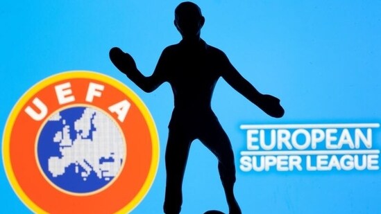 FILE PHOTO: A metal figure of a football player with a ball is seen in front of the words "European Super League" and the UEFA logo in this illustration(REUTERS)
