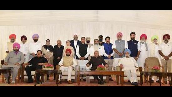 Punjab chief minister Charanjit Singh Channi with his team of ministers after they were sworn in by governor Banwarilal Purohit on Sunday. (HT Photo)
