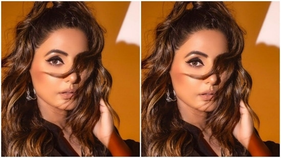 The velvety black attire has a plunging neckline with Mandarin collars.(Instagram/@realhinakhan)