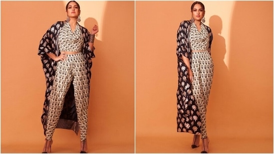 For the first look, Sonakshi chose a monochromatic outfit. The actor wore an off-white printed crop top with matching billowy pants. The top came with a layered drop sleeve and cropped hem. She teamed the co-ord set with a black embroidered cape, embellished strappy pumps, silver bracelet, rings, and oxidised silver jhumkas.(Instagram/@aslisona)