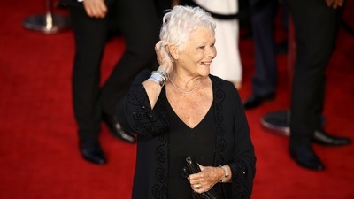 Actor Judi Dench smiles for the shutterbugs as she arrives at the world premiere of the new James Bond film No Time To Die. (REUTERS)