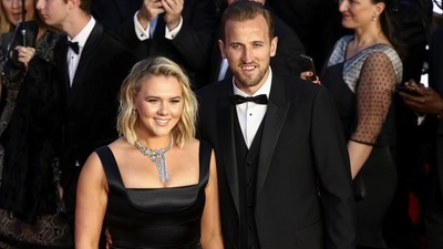 Soccer player Harry Kane and his wife Katie Goodland pose as they arrive at the world premiere of No Time To Die at the Royal Albert Hall in London. (REUTERS)