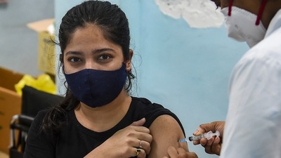 A woman receives a Covid-19 vaccine dose in Mumbai. (PTI) A woman receives a Covid-19 vaccine dose in Mumbai. (PTI)