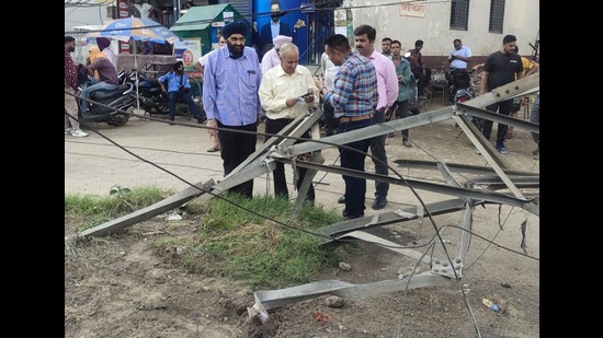 The damaged 66-kv electricity tower at Gill Road on Tuesday. Following the accident, power outages were reported from nearby areas. (HT photo)