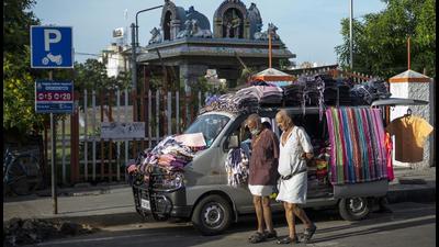 Pedestrians pass by a vehicle being used as a mobile clothes store in Chennai, India. The project involves the construction of an environment-friendly new corridor in Chennai’s metro network as part of Chennai Metro Rail Phase 2, the Asian Infrastructure Investment Bank said (Bloomberg) Pedestrians pass by a vehicle being used as a mobile clothes store in Chennai, India. The project involves the construction of an environment-friendly new corridor in Chennai’s metro network as part of Chennai Metro Rail Phase 2, the Asian Infrastructure Investment Bank said (Bloomberg)