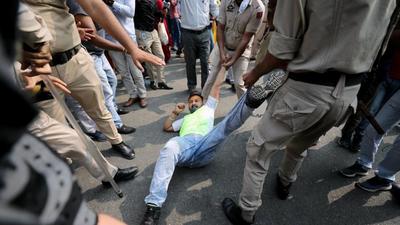 Police personnel detaining a NHM worker during a protest outside Government Medical College in Jammu on Thursday. (Shanky Rathore/ANI) Police personnel detaining a NHM worker during a protest outside Government Medical College in Jammu on Thursday. (Shanky Rathore/ANI)