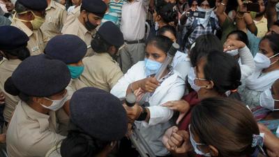 Nurses and other healthcare staff from Punjab holding a protest outside the Punjab Raj Bhawan in Chandigarh on Thursday. (HT Photo)