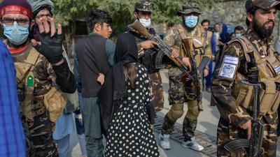 A Taliban fighter (left) makes a hand gesture asking photojournalists to stop covering a demonstration by women protestors in Kabul on Thursday. Top US generals told lawmakers at a congressional hearing that America lost the Afghanistan war and that it was caused by miscalculations spanning several administrations. (AFP) A Taliban fighter (left) makes a hand gesture asking photojournalists to stop covering a demonstration by women protestors in Kabul on Thursday. Top US generals told lawmakers at a congressional hearing that America lost the Afghanistan war and that it was caused by miscalculations spanning several administrations. (AFP)