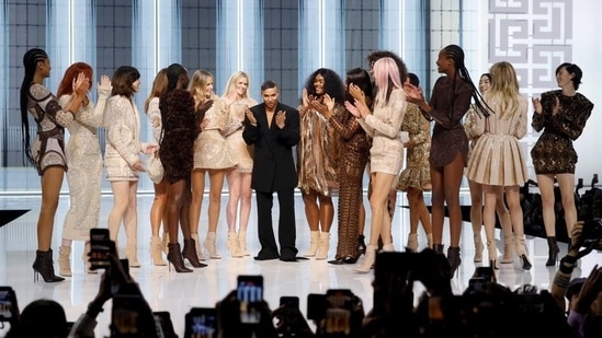Designer Olivier Rousteing appears with Carla Bruni, Naomi Campbell, Milla Jovovich and models presenting his creations at the end of his Spring/Summer 2022 women's ready-to-wear collection show for fashion house Balmain during Paris Fashion Week in Paris, France,&nbsp;(REUTERS/Stephane Mahe)
