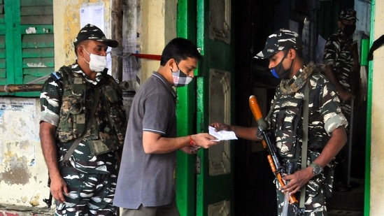 Kolkata: A paramilitary jawan checks the voter slip of a voter at a polling station during voting for Bhabanipur Assembly bypolls, in Kolkata, Thursday, Sept. 30, 2021. Kolkata: A paramilitary jawan checks the voter slip of a voter at a polling station during voting for Bhabanipur Assembly bypolls, in Kolkata, Thursday, Sept. 30, 2021. 