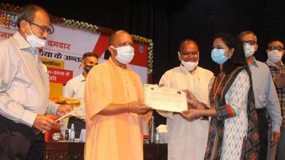 Uttar Pradesh chief minister Yogi Adityanath handing over an appointment letter at a function in Lucknow on Friday. (HT Photo) Uttar Pradesh chief minister Yogi Adityanath handing over an appointment letter at a function in Lucknow on Friday. (HT Photo)