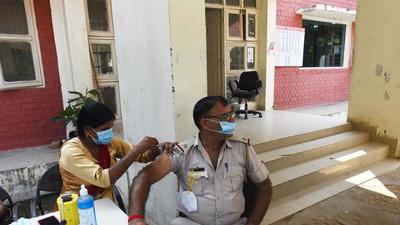 A police personnel gets vaccinated at the Sector 56 police station, in Gurugram on Friday. (Vipin Kumar /HT) A police personnel gets vaccinated at the Sector 56 police station, in Gurugram on Friday. (Vipin Kumar /HT)