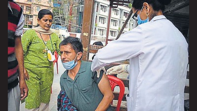 A health worker administering a Covid vaccine to a beneficiary in Shimla on Friday. (HT Photo)