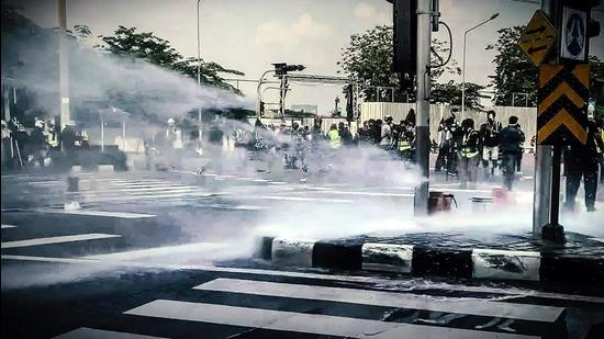 Haryana police use water cannon to disperse protesting farmers who trespassed barricades ahead of deputy CM Dushyant Chautala's programme, in Jhajjar on Friday. (PTI) Haryana police use water cannon to disperse protesting farmers who trespassed barricades ahead of deputy CM Dushyant Chautala's programme, in Jhajjar on Friday. (PTI)