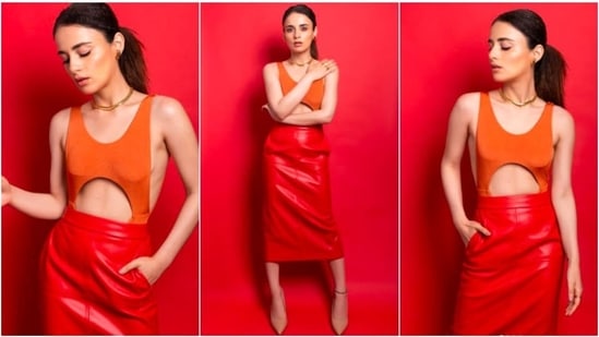 Recently, Radhika Madan shared a few pictures of herself in an orange cutout crop top and red high waisted fitted skirt.(Instagram/@radhikamadan)