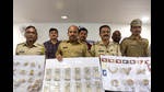 Police officials with the recovered stolen cash and valuables after the arrest of two thieves who looted houses posing as watchmen at APMC, Vashi, Navi Mumbai, on Saturday. (BACHCHAN KUMAR/HT PHOTO) Police officials with the recovered stolen cash and valuables after the arrest of two thieves who looted houses posing as watchmen at APMC, Vashi, Navi Mumbai, on Saturday. (BACHCHAN KUMAR/HT PHOTO)