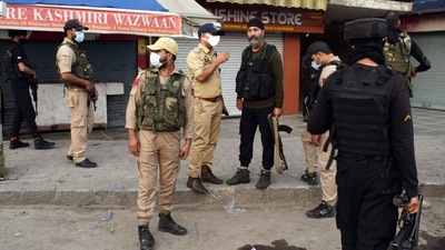 Security personnel stand guard near the incident site after a civilian was allegedly killed by the militants, at Karan Nagar, in Srinagar on Saturday. (ANI Photo) (Imran Nissar)