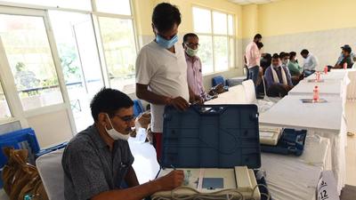 Gurugram, India - Oct. 2, 2021: Poling officials examine voting machines during the preparation for MCG by-polls of Ward Number 34 at Community Centre, Sector 27, in Gurugram, India, on Saturday, October 2, 2021. (Photo by Vipin Kumar / Hindustan Times) (Vipin Kumar /HT PHOTO) Gurugram, India - Oct. 2, 2021: Poling officials examine voting machines during the preparation for MCG by-polls of Ward Number 34 at Community Centre, Sector 27, in Gurugram, India, on Saturday, October 2, 2021. (Photo by Vipin Kumar / Hindustan Times) (Vipin Kumar /HT PHOTO)