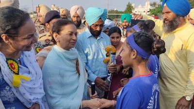 Cabinet minister Aruna Chaudhary interacting with hockey players at Government High School, Mundian Kalan, in Ludhiana on Saturday. (HT Photo)