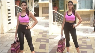 Nora rounded off her gym look with a Christian Dior Book Tote Embroidered Canvas Bag and added a luxurious touch with it. The expensive bag is worth  <span class='webrupee'>₹</span>2,22,435 (USD 3,000). (HT Photo/Varinder Chawla)