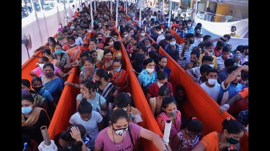 People wait for vaccination against Covid at a Thane Municipal Corporation centre in Diva on Saturday. (PRAFUL GANGURDE/HT PHOTO)