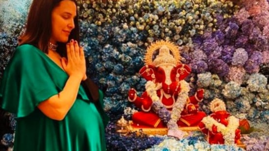 For Ganesh Chaturthi, Neha Dhupia styled herself in a green satin dress.(Instagram/@nehadhupia)