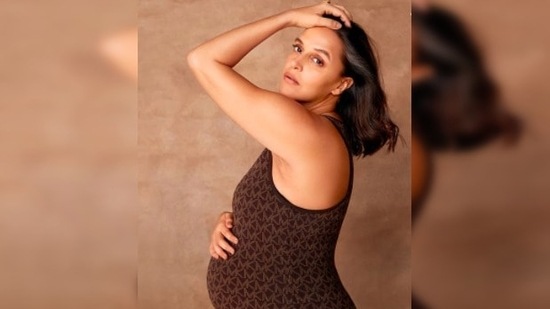 In another, Neha Dhupia flaunted her baby bump as she posed for the camera in a brown printed sleeveless bodycon dress.(Instagram/@nehadhupia)