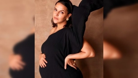 In one of the stills, Neha Dhupia can be seen wearing a black one-shoulder asymmetrical. With her hair open, Neha opted for neutral makeup.(Instagram/@nehadhupia)