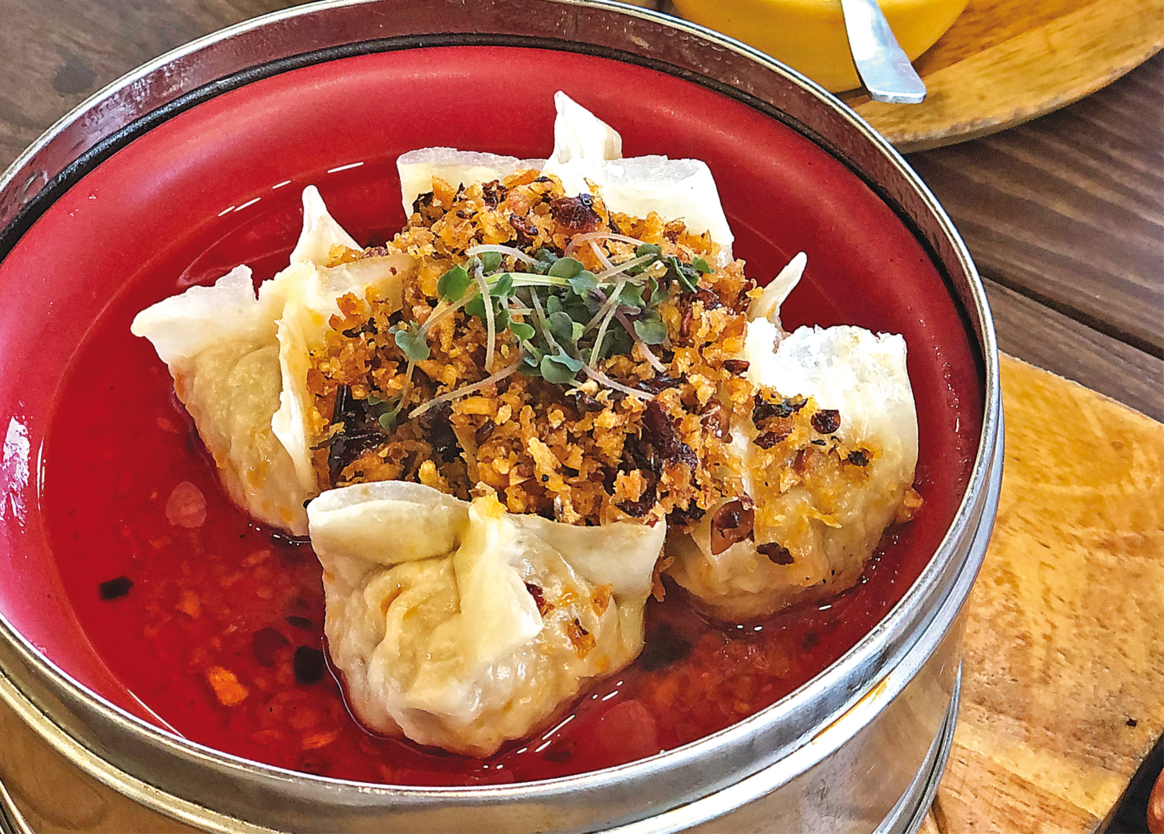 A favourite (non-authentic) dim sum is a dumpling in a light red sauce topped with crispy fried garlic