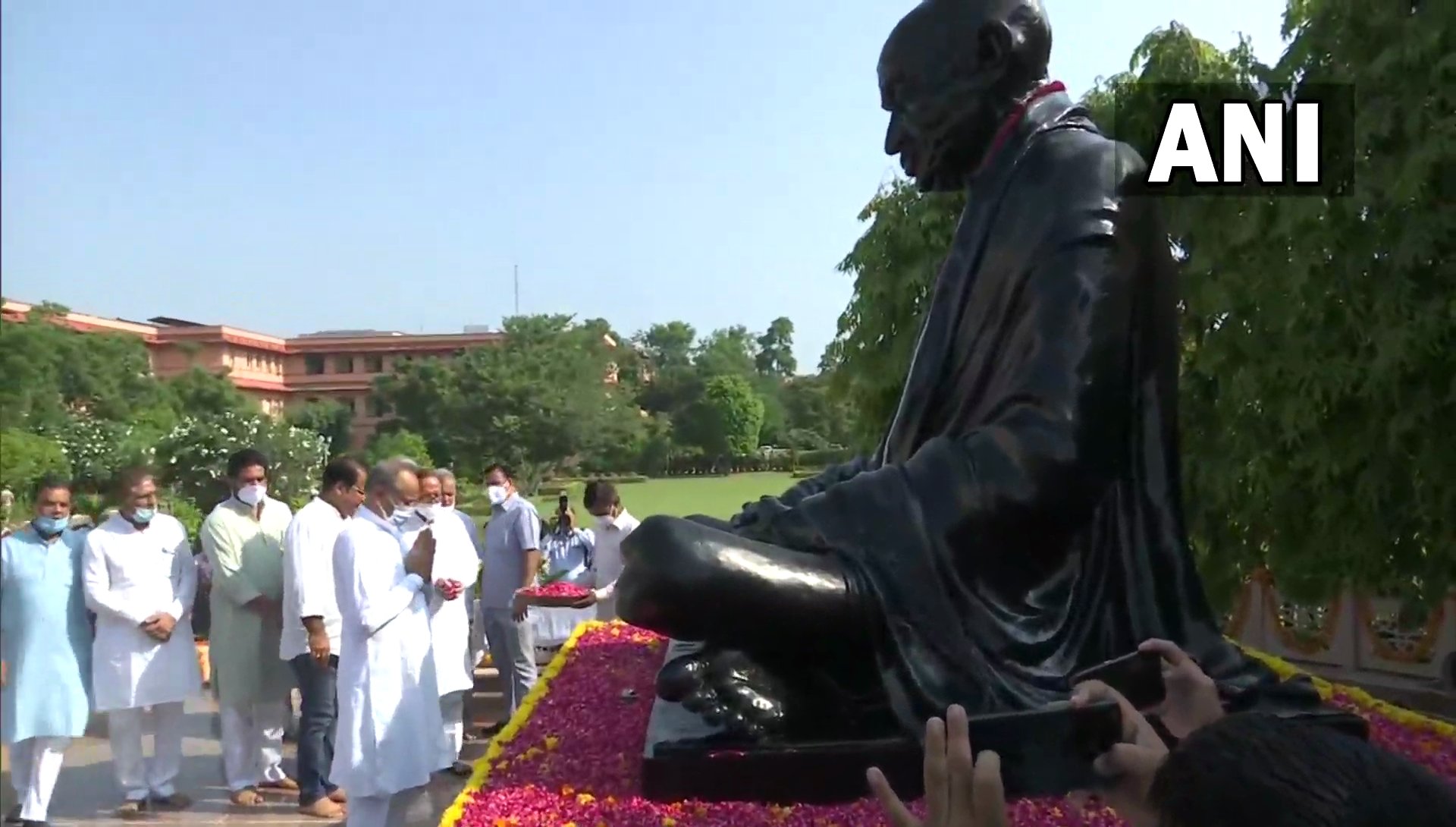 Rajasthan chief minister Ashok Gehlot pays tribute to Mahatma Gandhi by offering flowers to the statue of Gandhi in Jaipur to mark the occasion. ( ANI) Rajasthan chief minister Ashok Gehlot pays tribute to Mahatma Gandhi by offering flowers to the statue of Gandhi in Jaipur to mark the occasion. ( ANI)