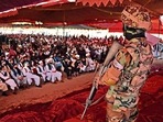 A Taliban fighter stands guard as people attend an open-air rally in a field on the outskirts of Kabul.(AFP) A Taliban fighter stands guard as people attend an open-air rally in a field on the outskirts of Kabul.(AFP)