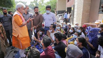 Jammu and Kashmir L-G Manoj Sinha meeting the healthcare staff protesting against the termination of their contract on Sunday. (PTI) Jammu and Kashmir L-G Manoj Sinha meeting the healthcare staff protesting against the termination of their contract on Sunday. (PTI)