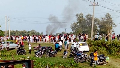 A vehicle set ablaze after violence broke out after farmers agitating were allegedly run over by a vehicle in the convoy of a union minister, in Lakhimpur Kheri. (PTI)