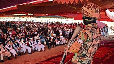 A Taliban fighter stands guard as people attend an open-air rally in a field on the outskirts of Kabul. (AFP) A Taliban fighter stands guard as people attend an open-air rally in a field on the outskirts of Kabul. (AFP)