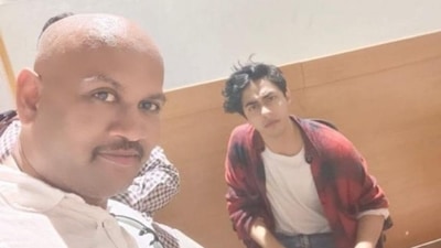 A man takes a selfie with Shah Rukh Khan's son Aryan Khan during the latter's questioning at NCB office in connection to a drug case. (ANI)