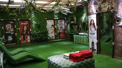 The washroom area has artificial grass chairs and creepers hanging from the ceiling and walls. The washroom area has artificial grass chairs and creepers hanging from the ceiling and walls. 