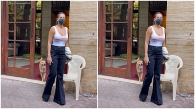 On Sunday, the actor was spotted by paparazzi in Bandra and she again set high standards with her outfit. Her simple yet stylish attire for the day included a white tank top perfectly showing off her midriff and a pair of black high-waisted jeans. (HT Photos/Varinder Chawla)
