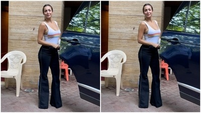 Malaika pulled her hair to the back and tied it in a clean ponytail. Before getting into the car, she posed for the paparazzi outside her Bandra home. She also carried her blazer in hand to be worn later. We’re taking notes of the actor’s fashionable outfits on how to look so stylish and yet be comfortable in summer clothes. (HT Photos/Varinder Chawla)