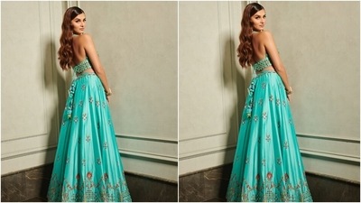 Popular celebrity stylist Shaleena Nathani styled Tara's ethnic look. She accessorised the lehenga set with vintage gold, pearl and emerald adorned bracelets and statement-making chandelier-style earrings. Her jewels are from Parina International. (Instagram/@punitbalana)
