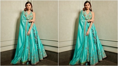 Tara teamed the blouse with a turquoise silk chanderi lehenga adorned with Resham and mirror work, thread tassels, and an embellished gotta patti border. The star rounded off her attire by draping an organza silk dupatta, decorated with mirror work, on her shoulder. (Instagram/@punitbalana) Tara teamed the blouse with a turquoise silk chanderi lehenga adorned with Resham and mirror work, thread tassels, and an embellished gotta patti border. The star rounded off her attire by draping an organza silk dupatta, decorated with mirror work, on her shoulder. (Instagram/@punitbalana)