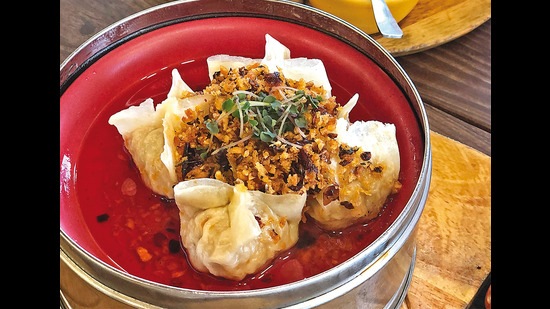 A favourite (non-authentic) dim sum is a dumpling in a light red sauce topped with crispy fried garlic A favourite (non-authentic) dim sum is a dumpling in a light red sauce topped with crispy fried garlic