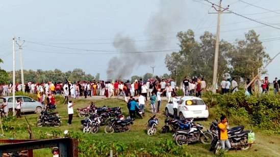 A vehicle set ablaze after violence broke out after farmers agitating were allegedly run over by a vehicle in the convoy of a union minister, in Lakhimpur Kheri.(PTI)