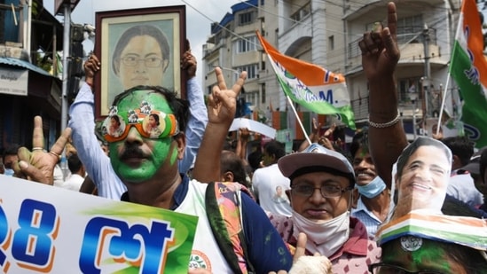 Trinamool Congress supporters celebrate near CM Mamata Banerjee's residence in Kolkata on Sunday. (Samir Jana/HT Photo)