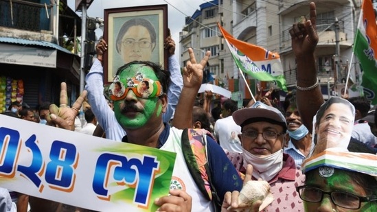 Trinamool Congress supporters celebrate near CM Mamata Banerjee's residence in Kolkata on Sunday. (Samir Jana/HT Photo)